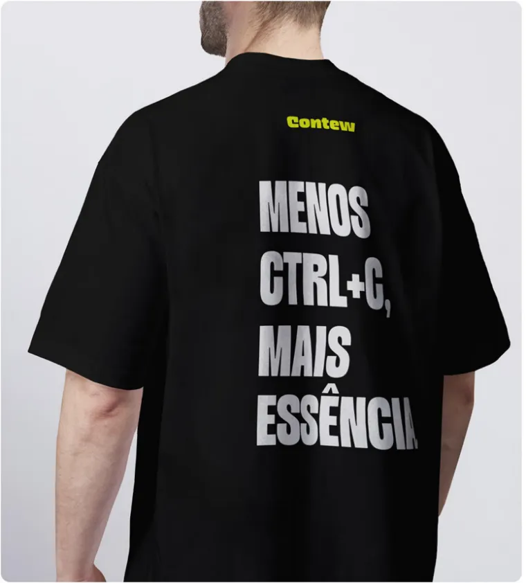 Costas de uma camiseta preta com a frase 'Menos Ctrl+C, mais essência' em letras brancas